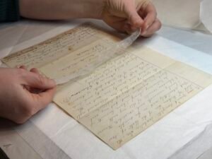 Applying a Japanese tissue mend to a document.